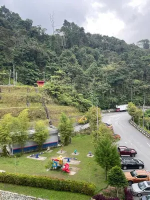 a park with a playground next to a road at Hanna Homestay Apartment for Muslim in Tanah Rata