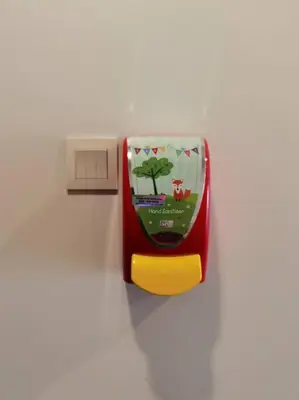 a red and yellow lightswitch on a white wall at Cameron Square, Nova Highlands - 1BR Studio Suite in Brinchang