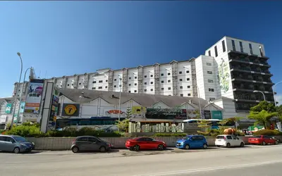 a large building with cars parked in a parking lot at Cameron Square, Nova Highlands - 1BR Studio Suite in Brinchang