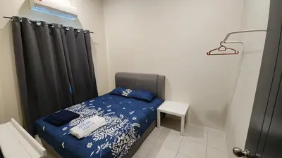 a small bedroom with a bed and a black curtain at Homestay LK in Sitiawan