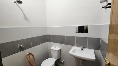 a bathroom with a toilet and a sink at Homestay LK in Sitiawan