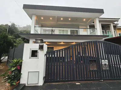 a house with a black gate in front of it at Spacious Corner Landed House Golden Hills Night Market in Brinchang