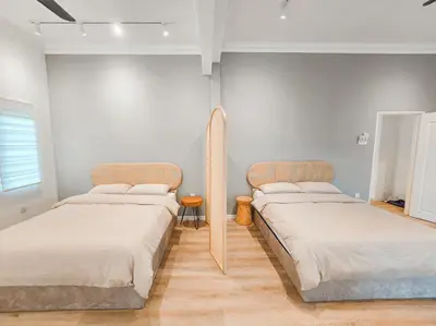 two beds in a room with white walls at Spacious Corner Landed House Golden Hills Night Market in Brinchang