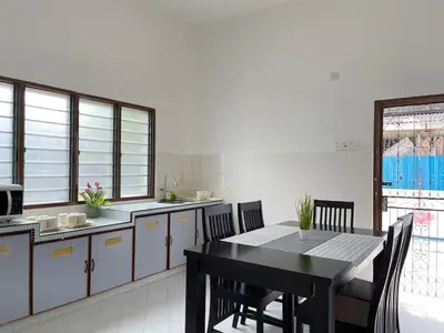 a kitchen with a table and chairs in a room at Comfort Semi D House, 1 min to Town by Mr Homestay in Teluk Intan