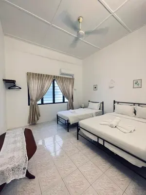 a bedroom with two beds and a window at Comfort Semi D House, 1 min to Town by Mr Homestay in Teluk Intan