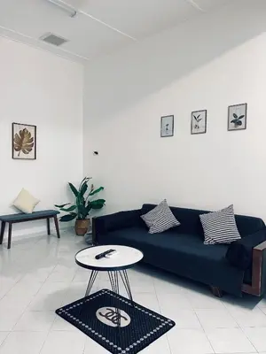 a living room with a blue couch and a table at Comfort Semi D House, 1 min to Town by Mr Homestay in Teluk Intan
