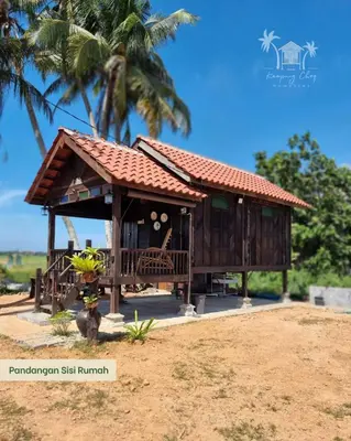 a small house with a roof on a beach at Kampung Cheq Homestay - Private Pool, Free Wifi, Netflix in Penaga