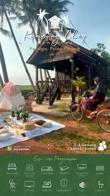 a person riding a bike in front of a house at Kampung Cheq Homestay - Private Pool, Free Wifi, Netflix in Penaga