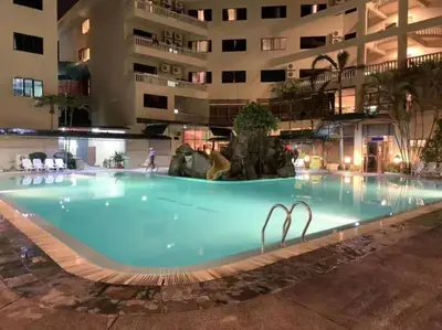 a large swimming pool in the middle of a building at Pangkor Island CoralBay Private Apartment in Pasir Bogak