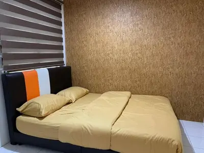 a bed in a room with a wall at Pangkor Island CoralBay Private Apartment in Pasir Bogak