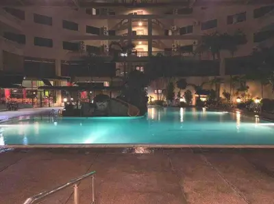 an empty swimming pool in a building at night at Pangkor Island CoralBay Private Apartment in Pasir Bogak