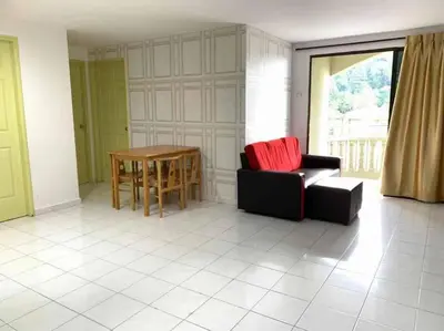 a living room with a couch and a table at Pangkor Island CoralBay Private Apartment in Pasir Bogak