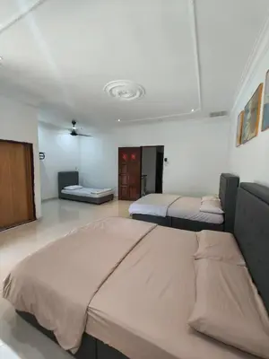 a bedroom with two beds in a room at Pangkor Island Seaside @ 4 rooms Homestay in Pasir Bogak