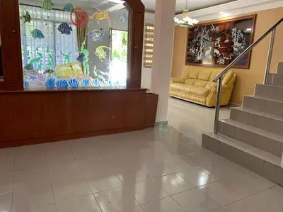 a lobby with a couch and stairs in a building at Pangkor Island Seaside @ 4 rooms Homestay in Pasir Bogak