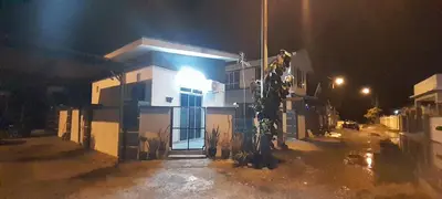a house with a light on the side of it at night at Studio Teratak Alisha Permatang Pauh in Permatang Pauh