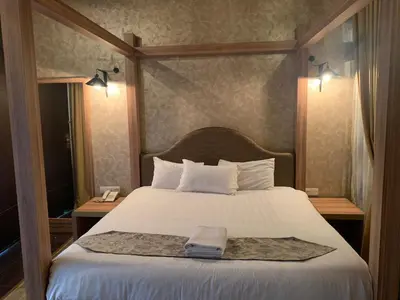 a bedroom with a bed with a towel on it at I Garden Hotel in Ipoh