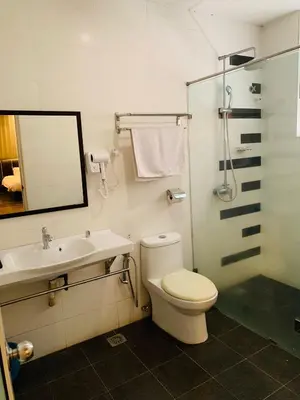 a bathroom with a toilet and a sink and a shower at I Garden Hotel in Ipoh