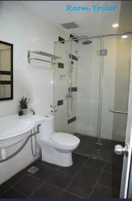 a bathroom with a toilet and a shower and a sink at I Garden Hotel in Ipoh