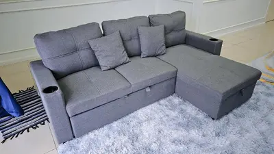 a gray couch in a living room with a rug at Homestay By MSH Seri Iskandar in Seri Iskandar