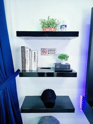 a shelf with a hat and books on it at Homestay By MSH Seri Iskandar in Seri Iskandar