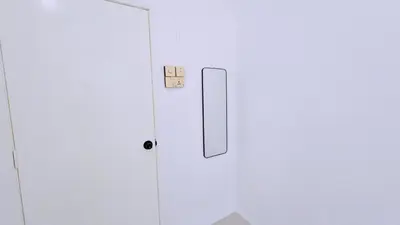 a white door in a white room with a switch at Homestay By MSH Seri Iskandar in Seri Iskandar