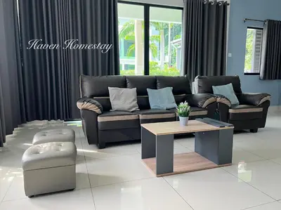 a living room with a couch and a coffee table at Haven Homestay\u6676\u6676\u5c4b (Brand New Homestay!) in Kampong Sungai Udang