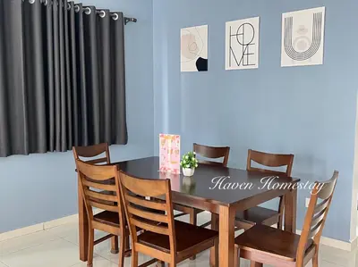 a dining room with a wooden table and chairs at Haven Homestay\u6676\u6676\u5c4b (Brand New Homestay!) in Kampong Sungai Udang