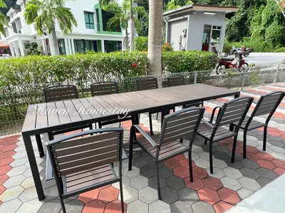 a wooden table and chairs on a patio at Haven Homestay\u6676\u6676\u5c4b (Brand New Homestay!) in Kampong Sungai Udang