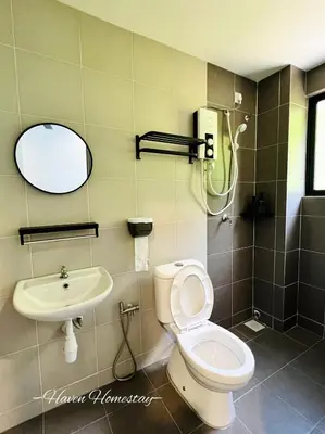 a bathroom with a toilet and a sink at Haven Homestay\u6676\u6676\u5c4b (Brand New Homestay!) in Kampong Sungai Udang