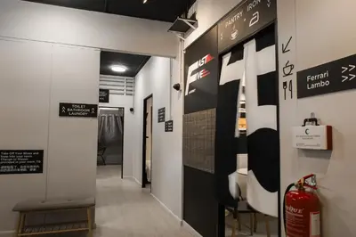 a hallway with a sign on the wall and a fire extinguisher at FAST FIVE At Gurney in Tanjong Tokong
