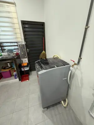 a small refrigerator sitting in a room with a garage at Mikhail's Homestay in Sungai Petani