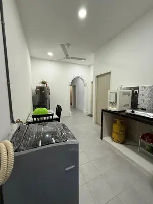 a kitchen with a counter top in a room at Mikhail's Homestay in Sungai Petani