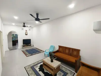 a living room with a couch and a tv at Mikhail's Homestay in Sungai Petani