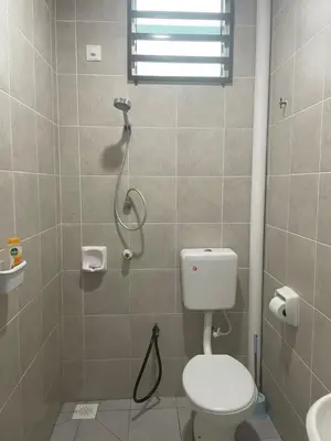a bathroom with a shower with a toilet and a sink at Mikhail's Homestay in Sungai Petani