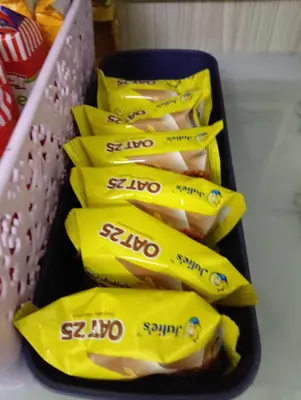 a group of yellow packets of chips in a container at Homestay Kak Ninie in Teluk Intan