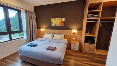 a bedroom with a large bed and a large window at H&W Sunway Onsen Suite Tambun Sunway City Ipoh in Ipoh