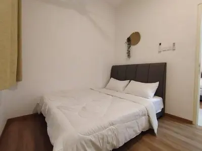 a bedroom with a large bed with white sheets at be.Bamboo The Cove-6mins Lost World Tambun-10pax in Ipoh