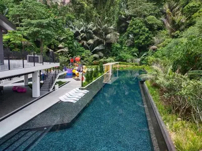 a pool at a resort with chairs and trees at be.Bamboo The Cove-6mins Lost World Tambun-10pax in Ipoh