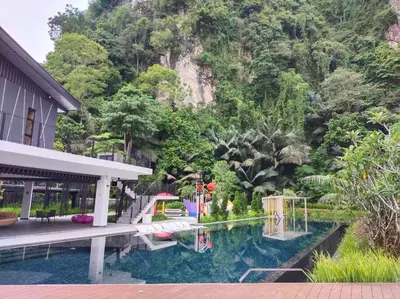 a house with a swimming pool in front of a mountain at be.Bliss-8mins Lost World Tambun-6-7pax in Ipoh