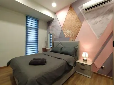 a bedroom with a large bed and a pink wall at be.Bliss-8mins Lost World Tambun-6-7pax in Ipoh