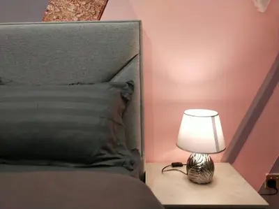 a small lamp sitting on a table next to a bed at be.Bliss-8mins Lost World Tambun-6-7pax in Ipoh