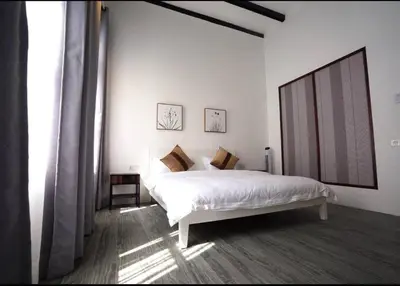 a white bedroom with a bed and a large window at Ipoh Old Town Heritage Family Suite-6R4B -12-16pax in Ipoh