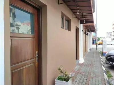 a door on the side of a building next to a sidewalk at Ipoh Old Town Heritage Family Suite-6R4B -12-16pax in Ipoh