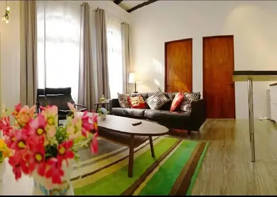 a living room with a couch and a table at Ipoh Old Town Heritage Family Suite-6R4B -12-16pax in Ipoh