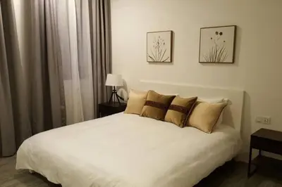 a bedroom with a large white bed with pillows at Ipoh Old Town Heritage Family Suite-6R4B -12-16pax in Ipoh