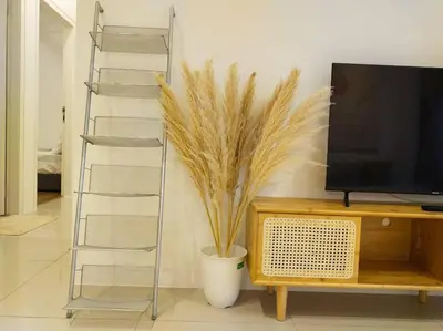 a living room with a tv and a plant at be.Cream The Cove -6mins Lost World Tambun -10pax in Ipoh