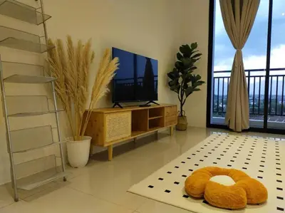 a living room with a flat screen tv and a couch at be.Cream The Cove -6mins Lost World Tambun -10pax in Ipoh