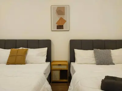 two beds sitting next to each other in a room at be.Cream The Cove -6mins Lost World Tambun -10pax in Ipoh