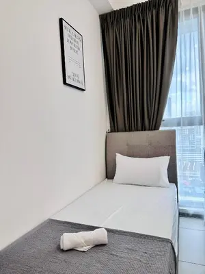a bedroom with a bed with a pillow on it at New 2BR or 3BR Cozy Urban Suite Homestay at Georgetown8-10pax by URBAN STAYCATIONS LOD COSY in Jelutong
