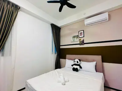 a panda bear sitting on top of a bed at New 2BR or 3BR Cozy Urban Suite Homestay at Georgetown8-10pax by URBAN STAYCATIONS LOD COSY in Jelutong
